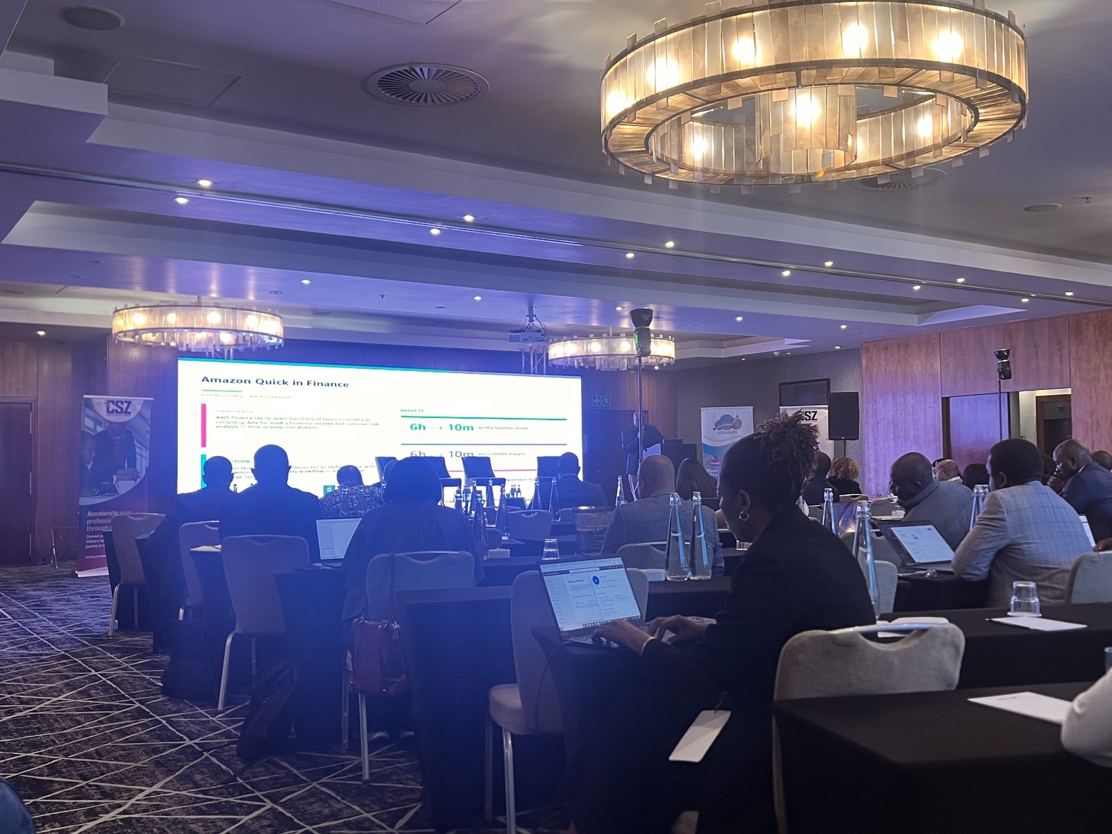 Conference room with delegates and a presentation on a large LED screen