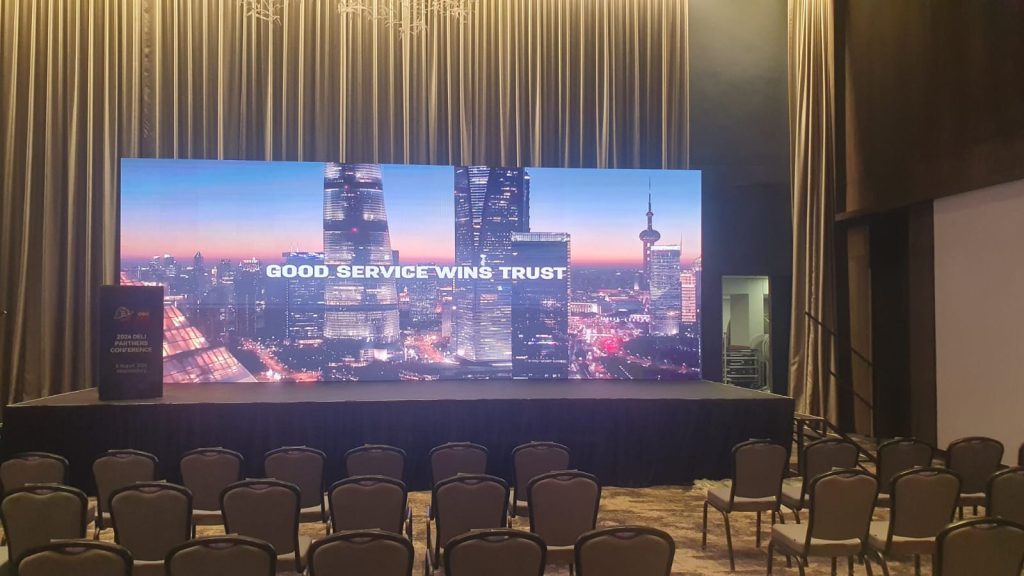 Corporate stage screen reading Good Service Wins Trust