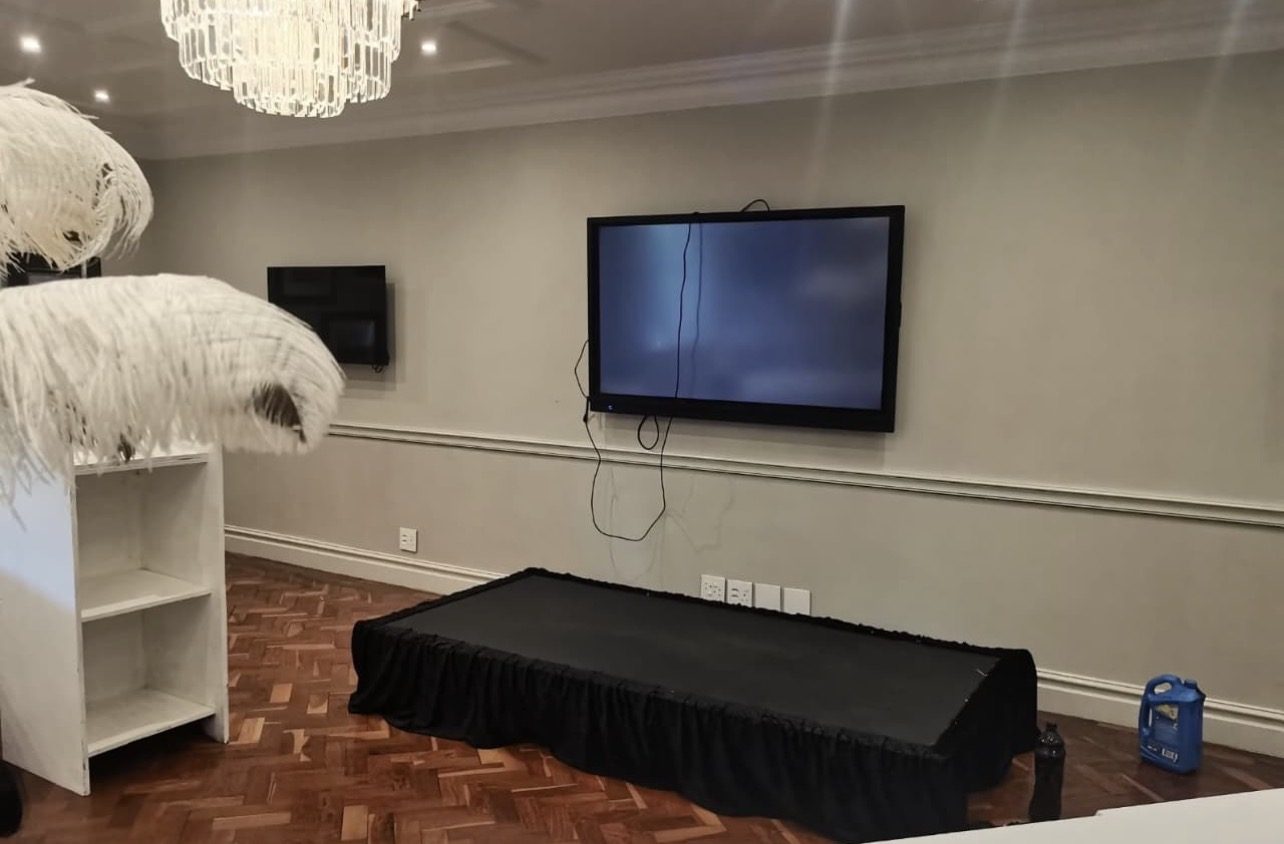 Screen mounted in a private home with a small stage